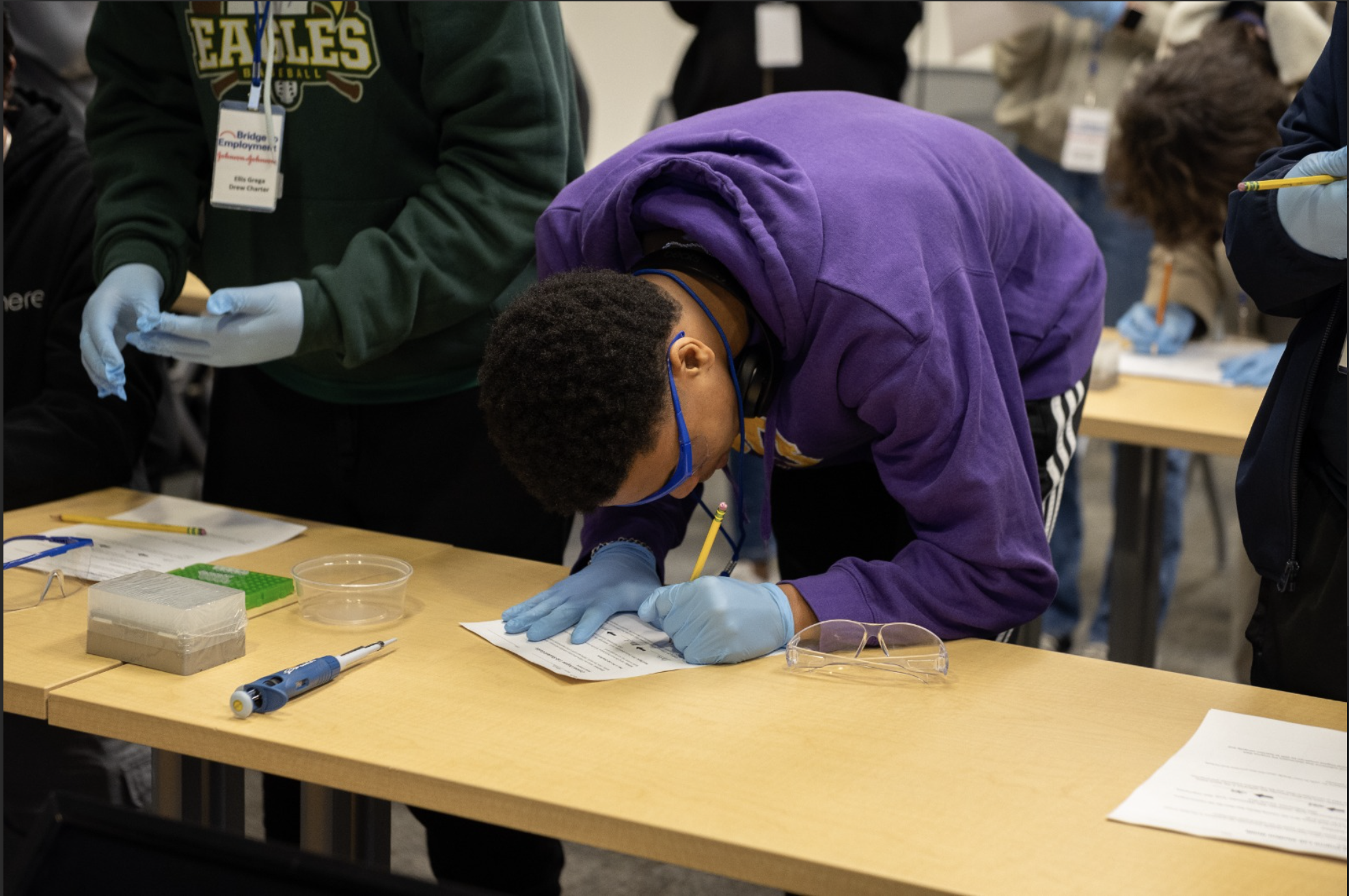 Student working on hands-on STEM project with safety equipment