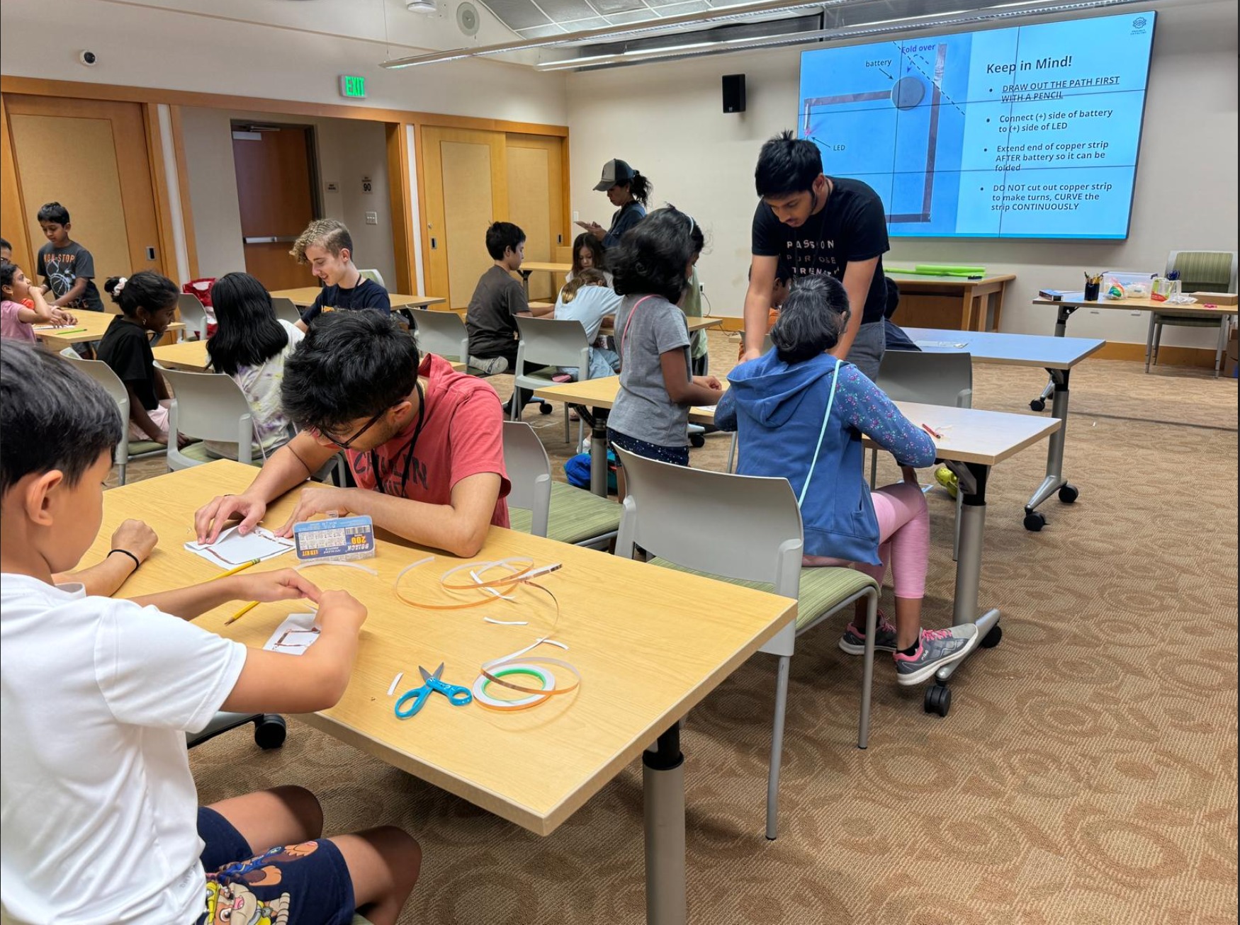 Students learning electronics with LED circuits and copper strips